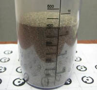 Sand in measuring cup